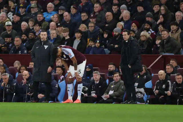 Mings stands on his haunches on the touchline