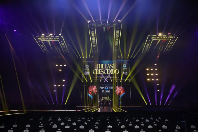 An empty arena with a large screen showing Artur Beterbiev and Dmitry Bivol under the words 'The Last Crescendo'