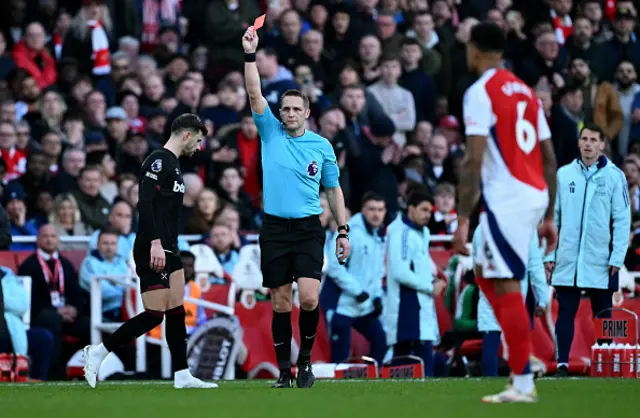 Referee Craig Pawson shows a red card