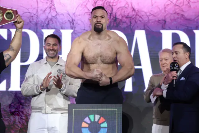 Joseph Parker is shirtless and flexing his muscles