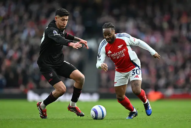 Raheem Sterling of Arsenal runs with the ball under pressure from Edson Alvarez