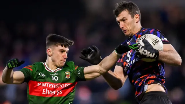 Armagh goalkeeper Ethan Rafferty attempts to fend off Mayo's Davitt Neary