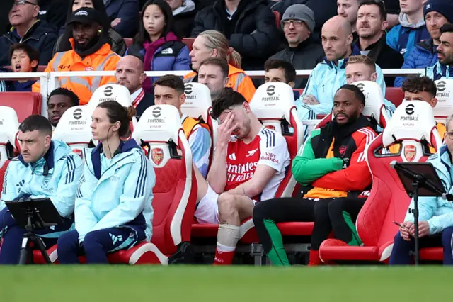 Declan Rice of Arsenal reacts, while sitting on the bench