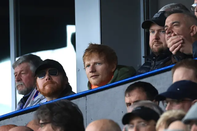 Ed Sheeran looks on