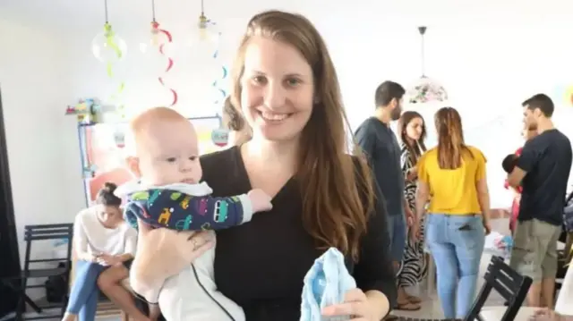 Shiri Bibas holding a baby