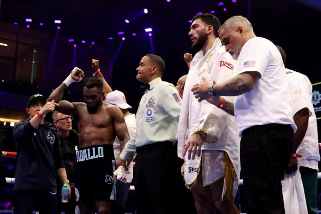 Carlos Adames lifts his hand in the air before the scorecards are read out