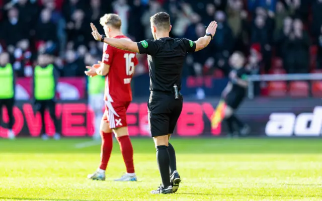 Referee Nick Walsh signals a change of heart over the Kilmarnock penalty decision