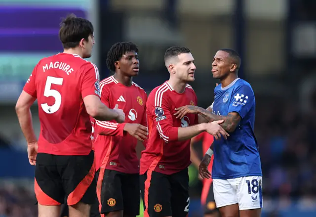 Ashley Young of Everton, and Harry Maguire of Manchester United are pictured talking