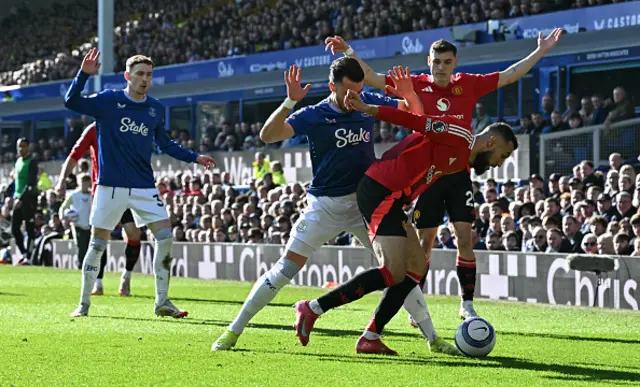 Jack Harrison (C) vies with Manchester United's Moroccan defender Noussair Mazraoui