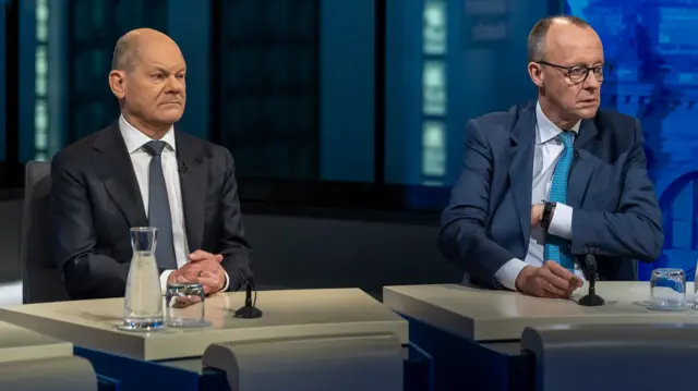 Friedrich Merz, right, sat next to Chancellor Olaf Scholz during this evening's TV debate