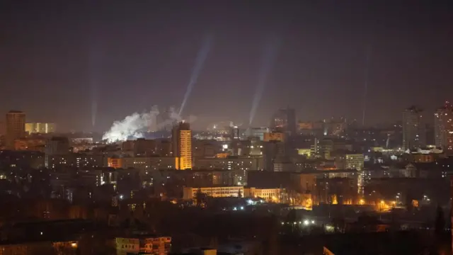 Ukrainian service personnel use searchlights as they search for drones in the sky over the city during a Russian drone strike, amid Russia's attack on Ukraine, in Kyiv, Ukraine February 23, 2025