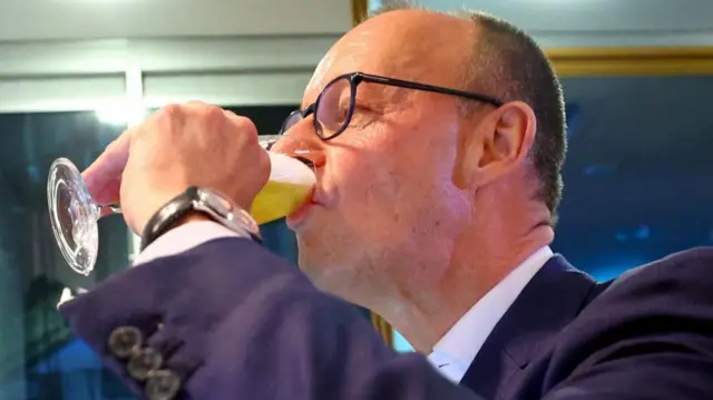 Friedrich Merz drinking beer