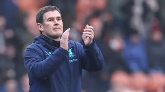 Mansfield Town boss Nigel Clough applauds the fans