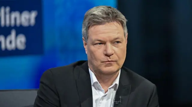 Robert Habeck wearing white shirt and black jacket, no tie.