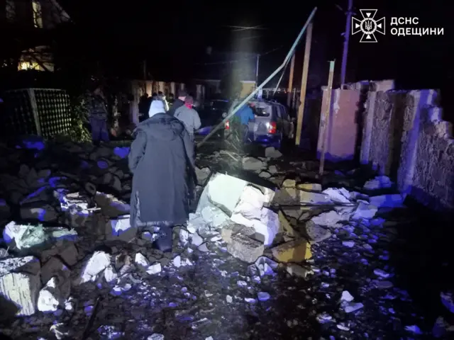 In Odesa, civilians survey the wreckage of destroyed buildings and vehicles