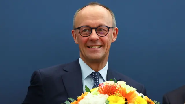 German conservative candidate for Chancellor and CDU director of Christo Democratic Union (CDU), Friedrich Merz, holds flowers