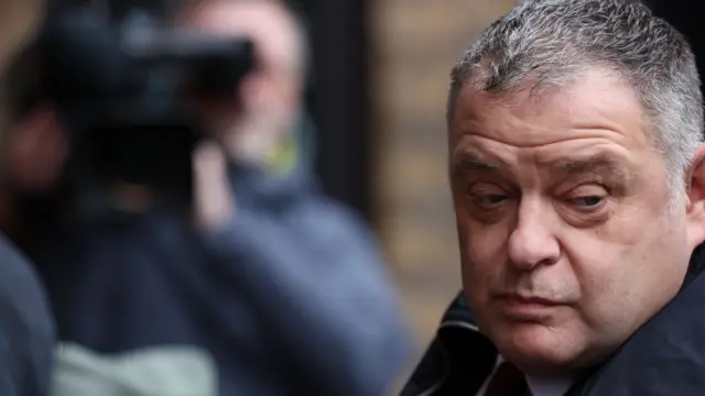 Mike Amesbury looks about while stood outside Chester Magistrates' Court