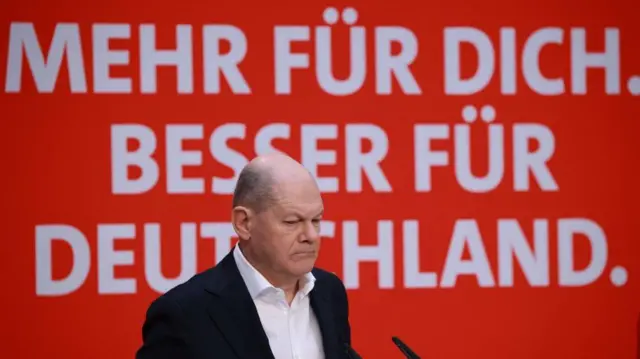 German Chancellor Olaf Scholz looks more for you in front of the slogan. Better for Germany. 'Since he takes part in the press conference of the Social Democratic Party