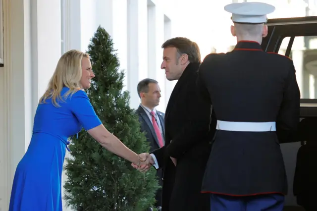 French President Emmanuel Macron is greeted by White House Chief of Protocol Monica Crowley as he arrives at the White House