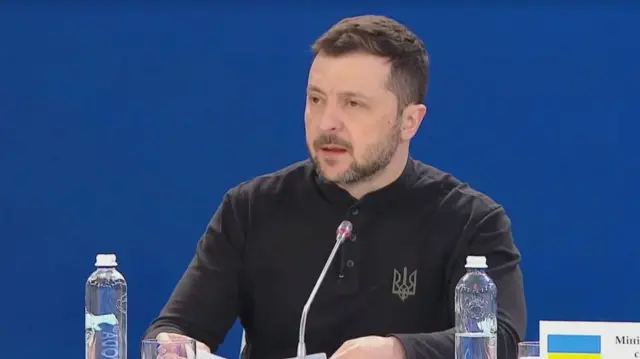 Zelensky speaking at the table