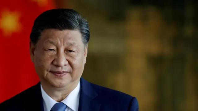 A file photo of Chinese leader Xi Jinping wearing a suit and standing in front of a Chinese flag