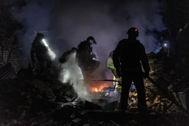 Ukrainian firefighters extinguish a fire in a building destroyed after Russian shelling of the city of Kostiantynivka, Ukraine