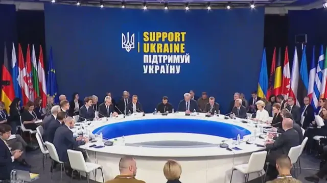 The Ukrainian president in the middle of the circular table surrounded by European leaders