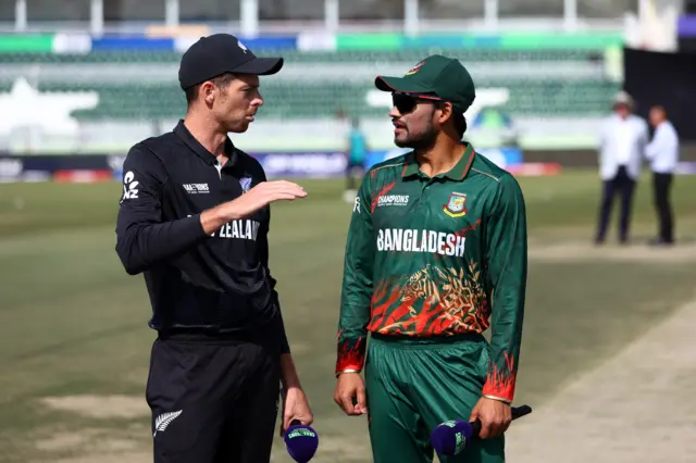 Mitchell Santner of New Zealand speaks to Nazmul Hossain Shanto of Bangladesh ahead of the ICC Champions Trophy 2025 match between Bangladesh and New Zealand at Rawalpindi Cricket Stadium