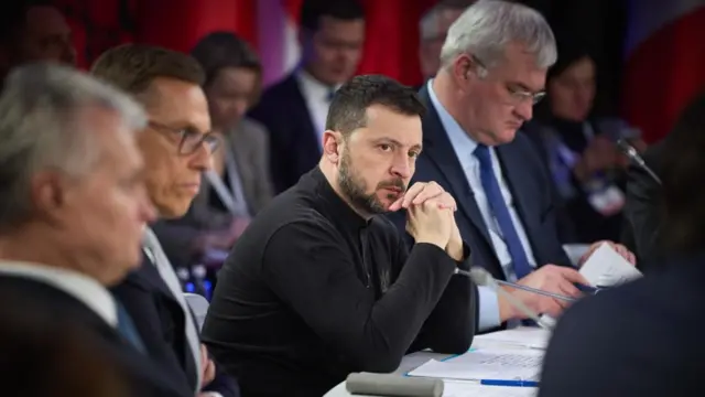 Zelensky sitting at a table at the summit in Kyiv today