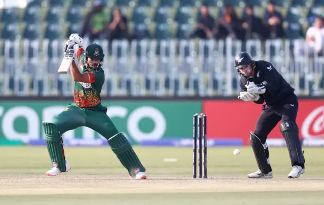 Nazmul Hossain Shanto of Bangladesh plays a shot as Tom Latham of New Zealand keeps