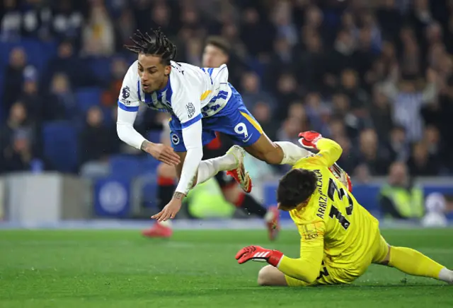 Joao Pedro of Brighton & Hove Albion is challenged by Kepa Arrizabalaga