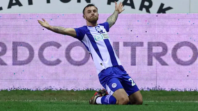 Dale Taylor of Wigan Athletic scores to make it 1-0 and celebrates