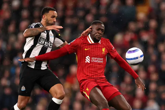 Ibrahima Konate of Liverpool is challenged by Callum Wilson