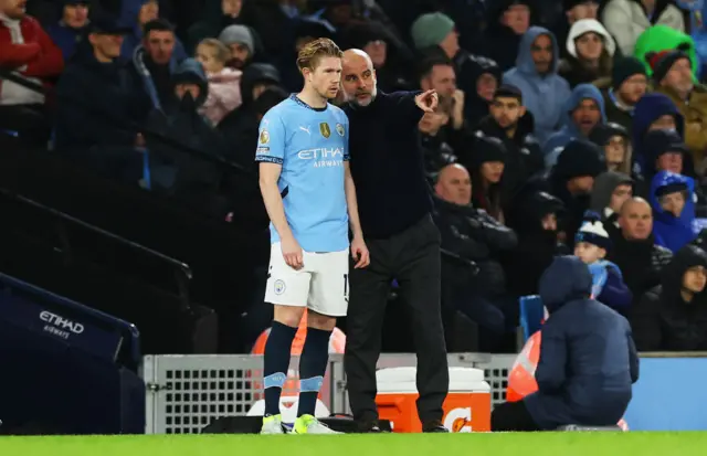 Kevin De Bruyne is instructed by Pep Guardiola