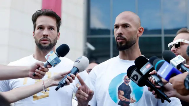 Influencer Andrew Tate (R) and his brother Tristan Tate (L) talk to the media in front of the Bucharest court after prosecution made new allegations of human trafficking and sex with a minor, in Bucharest, Romania, 22 August 2024.