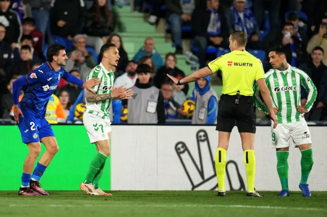 Antony of Real Betis reacts towards referee Javier Alberola Rojas, after receiving a red card