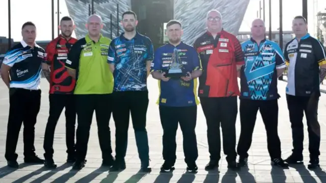 Premier League darts players and the trophy outside the arena in Belfast