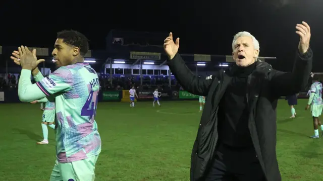 Mark Hughes (right) and Kadeem Harris celebrate the win with the Carlisle fans