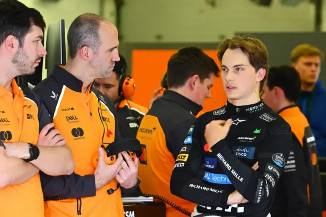 Oscar Piastri talks to his engineers in the McLaren garage