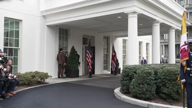 Uniformed personnel guard the entrance to the West Wing of the White House