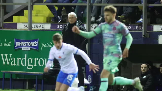 Mark Hughes stands on the touchline