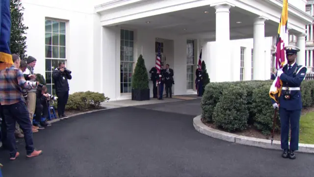 Uniformed personnel guard the entrance to the West Wing of the White House