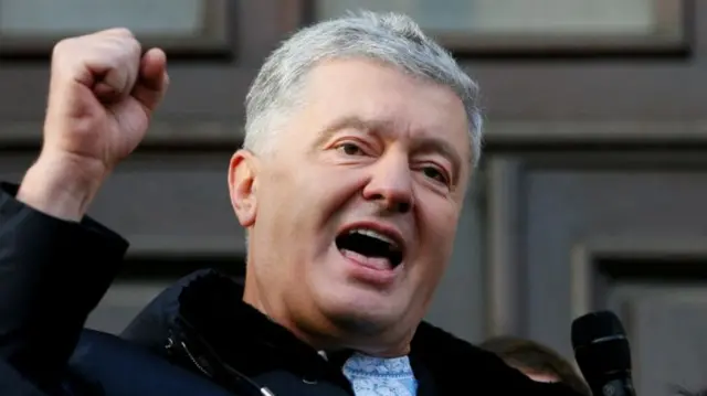 Ukrainian former President Petro Poroshenko speaking in mic with fist in air