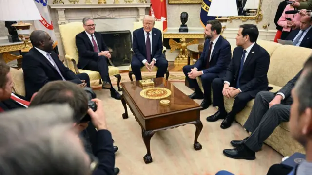 Trump, Starmer and officials sitting together in the Oval Office