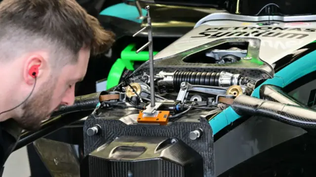 Mercedes engineer looking at the car