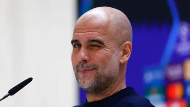 Pep Guardiola winking at news conference