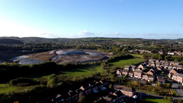 An aerial view of the Walleys Quarry landfill, pictured to the left of a housing estate.