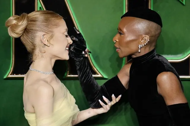 Cynthia Erivo applying Ariana Grande's make-up on the green carpet at a Wicked premiere