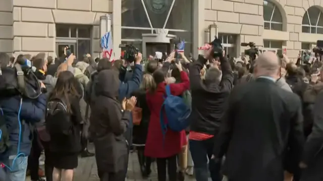 People standing outside the USAID building in Washington