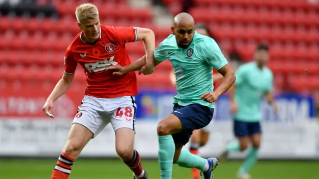 Zach Mitchell of Charlton Athletic and Ashley Chambers of Coalville Town in action during the Emirates FA Cup First Round match between Charlton Athletic and Coalville Town at The Valley